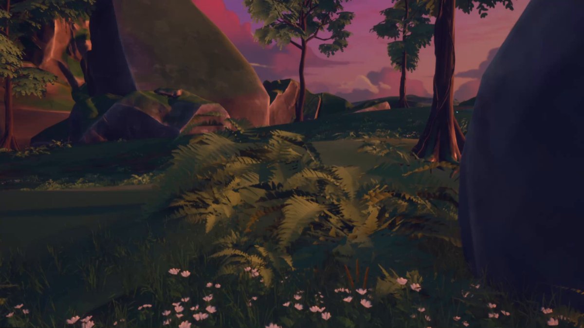 The image features a scene with a forest, grassy area, and rocks. The sky above has pink hues, creating an atmospheric setting for the scene. There are flowers scattered throughout the landscape, adding color and life to the environment. A person is present in the scene, standing near some of the rocks or trees.