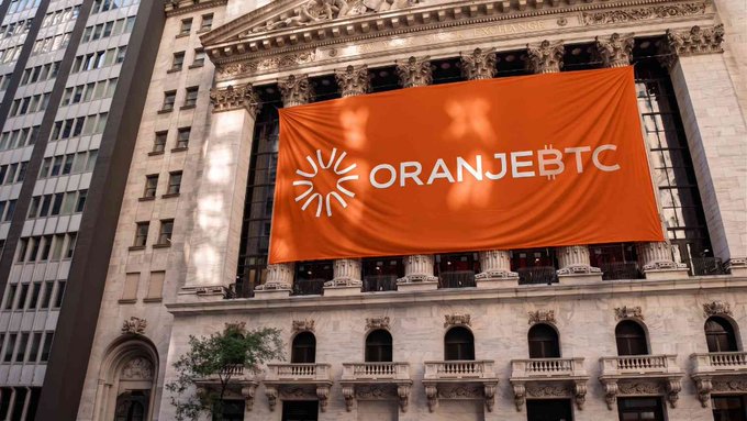 An orange banner displaying the 'ORANJEBTC' logo with a sun emblem is draped across the facade of a classical-style building with columns.
