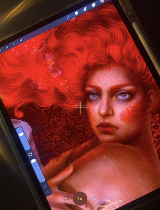 A close-up of a tablet screen showing a vibrant red-toned portrait of a woman with flowing hair, with camera zoom controls (1x, 3, 5) visible on the left side.