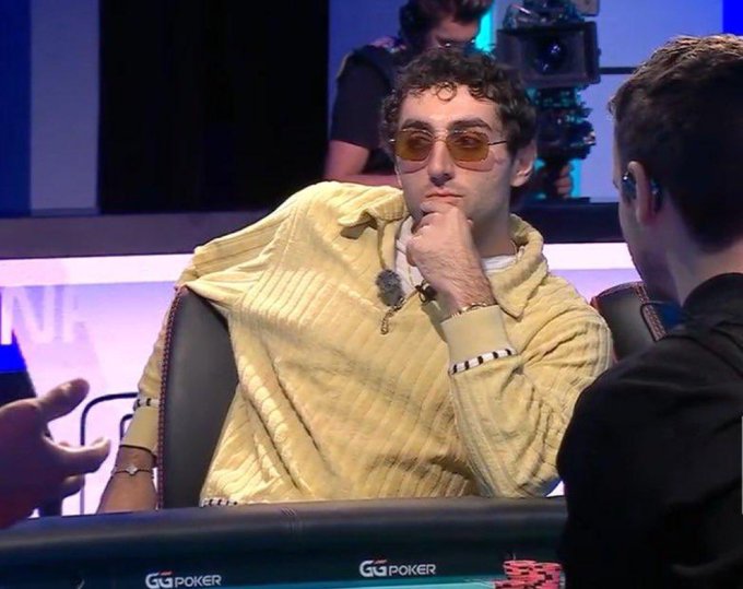 A poker player in sunglasses and a yellow sweater sits thoughtfully with his hand on his chin at a GG Poker table. The caption "Waiting for the CLARITY Act updates like…" humorously compares his contemplative, anticipation-filled expression to the uncertainty surrounding the CLARITY Act's progress.