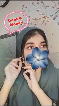 A selfie of a young woman wearing a dark hijab, with a blue flower digitally placed over her face and a pink speech bubble reading 'Genz & Money' in the top left corner.