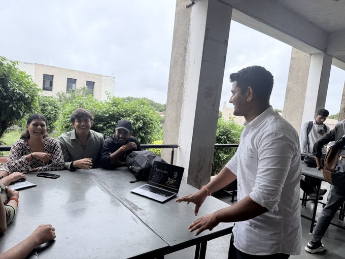 A speaker in a white shirt enthusiastically presents to a small group of attentive attendees seated around a table on an outdoor terrace, with a laptop displaying "Thank you" on its screen. The scene captures the Zcash community meetup focused on introducing newcomers to privacy-focused blockchain technology, particularly the new Ironwood (NU6.3) update and Zakura full node developments.
