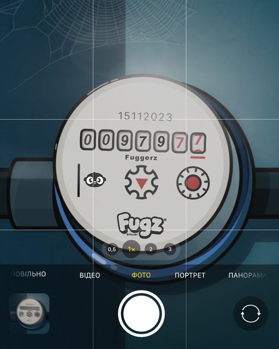 A smartphone camera app interface displaying a wristwatch with the code '009797' and 'Fuggerz' brand on its face, with photo mode selected.