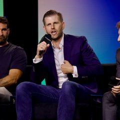 Eric Trump, seated on a stage in a purple blazer and speaking into a microphone, appears to be discussing his long-term bullish stance on Bitcoin, as referenced in the accompanying post about his statements to WOLF Financial.
