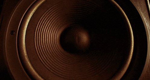 urn of a speaker with a large circular opening and a smaller circular opening at the top, set against a dark gray background.