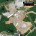 An aerial/satellite view of an industrial mining site or processing facility, labeled 'Whole Sand Complex,' surrounded by green forested terrain.