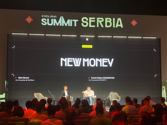 A panel discussion at the Solana Summit Serbia, featuring speakers including Vidor Gencel (Co-Founder @ Solfaire) and moderator Vukasin Stojkov (Co-Founder @ STARTIT), with the presentation title 'NEW MONEY' displayed on a large screen.