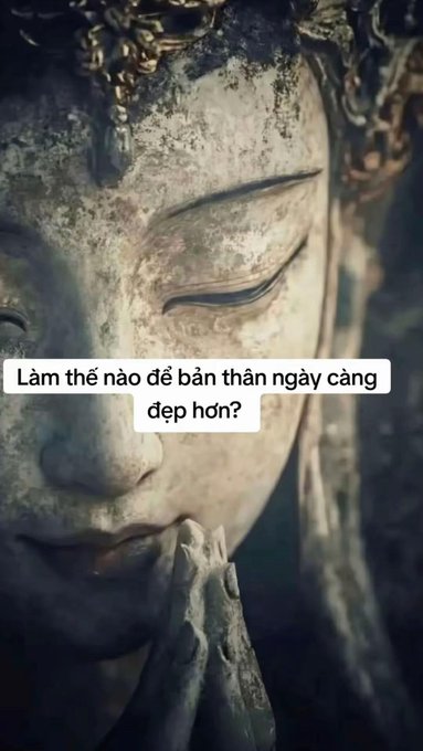 A close-up of a serene stone statue with Vietnamese text reading 'Làm thế nào để bản thân ngày càng đẹp hơn?' (How to make oneself more beautiful day by day?).