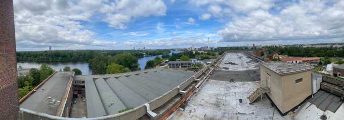 The image shows a panoramic view of a city skyline with a river running through it, as well as an aerial perspective of a building with a flat roof. The sky above appears cloudy, suggesting that the weather might be overcast or changing. In the image, there is also text that reads "New era of @Polkadot is upon us. Are you coming to @Web3summit ?". This could possibly be an advertisement for an event happening in the city or a reference to the current state of the cryptocurrency market. The focus on the building and its roof might indicate that it has some significance, such as being a landmark or a popular location within the city.