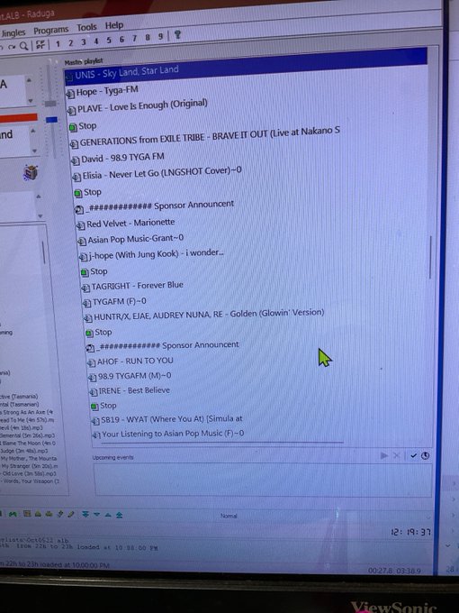 A computer monitor displaying a Winamp media player window with a 'Radio playlist' showing songs by artists like UNVS, PLAVE, GENERATIONS, and j-hope, with 'ViewSonic' visible at the bottom.