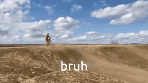 The image shows a person riding a dirt bike across a desert landscape with a cloudy sky above them. The caption of the image reads "brush", which could be interpreted as a reference to the type of terrain or activity taking place, such as off-road biking.