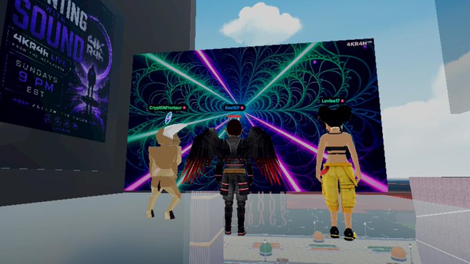 A screenshot from a virtual world or game featuring three avatars standing in front of a large psychedelic stage screen at an event called 'AKIRA LIVE,' with neon visuals and laser beams.