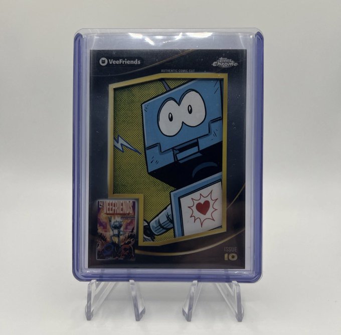 A graded VeeFriends "Authentic Comic Cut" card featuring a blue blocky character is displayed in a protective slab, marked "Issue 10." The caption "Oops I did it again" humorously references the buyer's return to collecting VeeFriends cards despite likely intending to curb the habit.