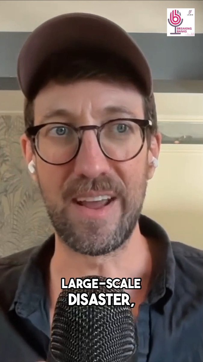 A man wearing a dark cap, glasses, and earbuds speaks into a microphone in a Breaking Banks podcast clip, with subtitle text reading 'LARGE-SCALE DISASTER,'