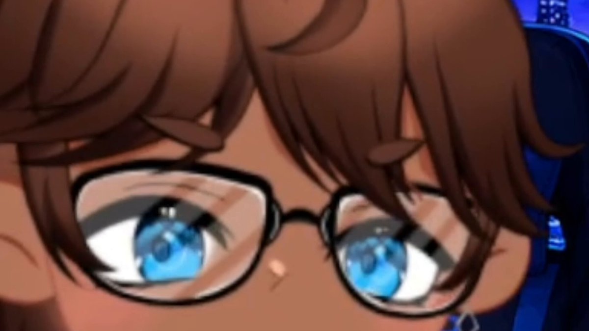 The image features a close-up of a person's face wearing glasses, giving an impression that they are peeking out from behind their glasses. The background appears to be dark blue with some white text visible at the bottom right corner. The main focus is on the person and their glasses, creating a sense of mystery or intrigue about what lies beyond them.