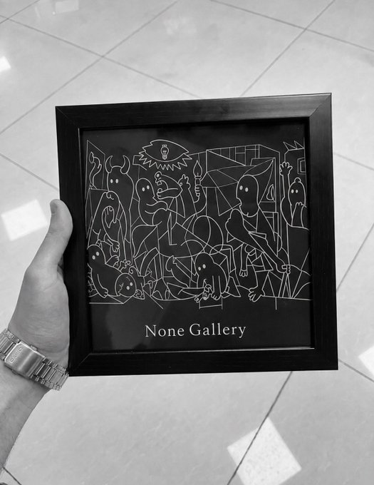 A black and white photo of a hand holding a framed artwork from the 'None Gallery' depicting ghost-like figures and creatures in a line-art style reminiscent of Picasso's Guernica.