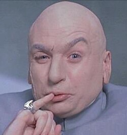 The image features an actor, possibly a character named Mr. Bean or Dr. Jekyll, posed with a serious expression as he makes a funny facial expression by sticking his finger in his mouth. The person wearing this face mask has a bald head, indicating that they may be an older individual, potentially of South Korean descent. A notable feature on the actor's face is the ring adorning their finger. This image appears to be related to the post where someone mentions South Korea winning the FIFA World Cup.
