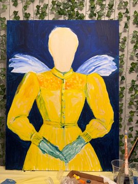 A partially completed painting of a faceless figure in a yellow dress with blue wings, showing the artist's work-in-progress against a dark blue background, capturing the "how it started" stage before final details are added.