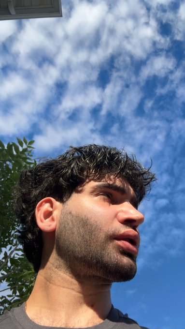 A close-up of a person's profile is shown against a sky with white clouds, possibly indicating an outdoor setting for the $SOL price giveaway.