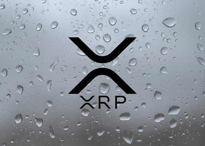 The XRP cryptocurrency logo displayed on a glass surface covered in water droplets, with the text 'XRP' beneath the stylized X symbol.