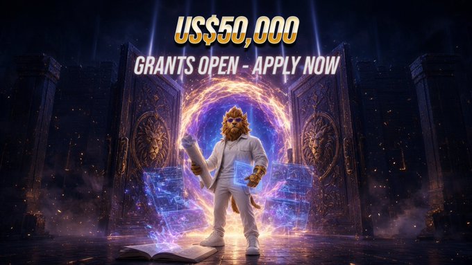 A fantasy-themed promotional graphic displays 'US$50,000 GRANTS OPEN - APPLY NOW' above a lion-headed figure in a white robe holding a scroll and tablet, standing before a magical portal flanked by lion statues.