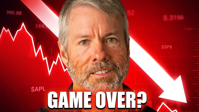 The image features an older man wearing glasses and a beard, with the words "game over?" written beneath him. The background of the photo has a red line going down, indicating a downward trend or decline, and there are numbers associated with the downward movement on this same background. These numbers represent a financial loss, which is attributed to Michael Saylor's failed investment in Bitcoin. The image seems to be related to an article about Saylor's strategy, as it displays both the person and the concept of "game over" or failure.