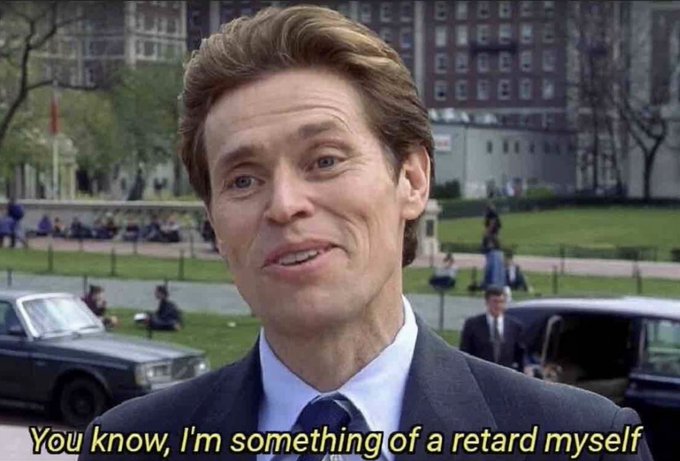 A man in a suit speaking outdoors on a university campus with caption text 'You know, I'm something of a retard myself'.