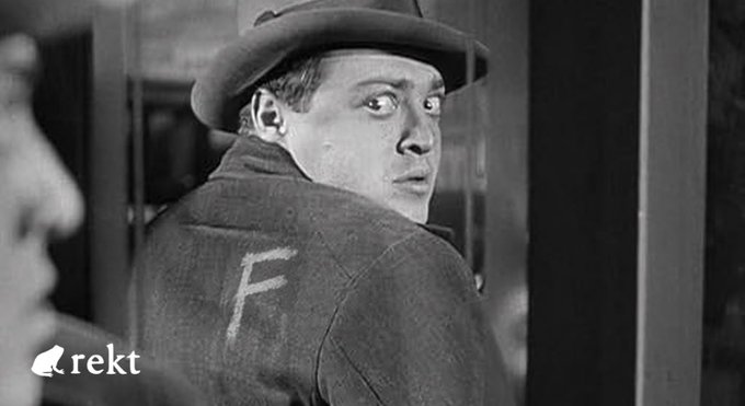 A black-and-white film still shows a wide-eyed man in a fedora and overcoat casting a suspicious backward glance, with the "rekt" logo in the bottom-left corner and a chalk-drawn "F" on his shoulder echoing the $FET token drained in the SingularityNET hack. His wary expression mirrors the post's warning about unchecked bridge signatures enabling the multi-asset exploit.