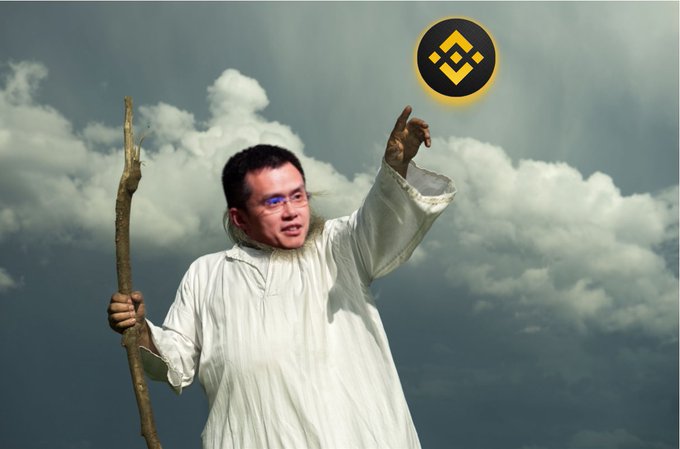 An edited image showing a person in white robes holding a wooden staff, pointing upward toward a Binance (BNB) cryptocurrency logo against a cloudy sky background.