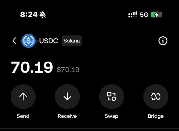 A screenshot of a crypto wallet app showing a USDC (Solana) balance of $70.19, with options to Send, Receive, Swap, or Bridge. The image visually supports the post's claim of a "$70 bagged" profit from the update.