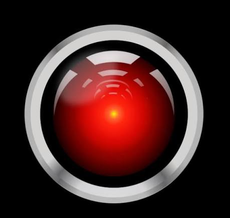 A red glowing orb or eye icon with a bright center, encased in a white and black circular frame against a dark background, reminiscent of the HAL 9000 from 2001: A Space Odyssey.