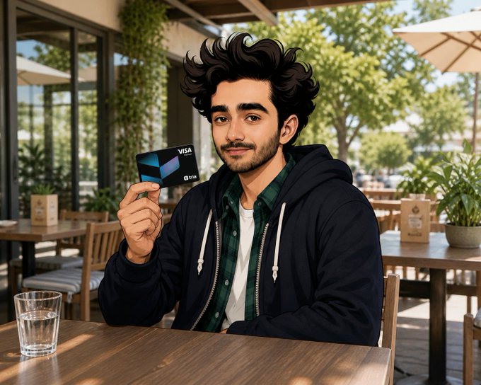 The image features a man sitting at an outdoor table, holding up a credit card with a Visa logo. The man appears to be wearing a jacket and has a beard. He is seated outside in front of some potted plants, suggesting that he might be enjoying his time outdoors or taking a break from work. The post about the Tria Card emphasizes the convenience of using digital wallets for everyday transactions, such as paying bills or making purchases at coffee shops. This aligns with the man's situation, as he is holding up a credit card to make a payment in an outdoor setting.