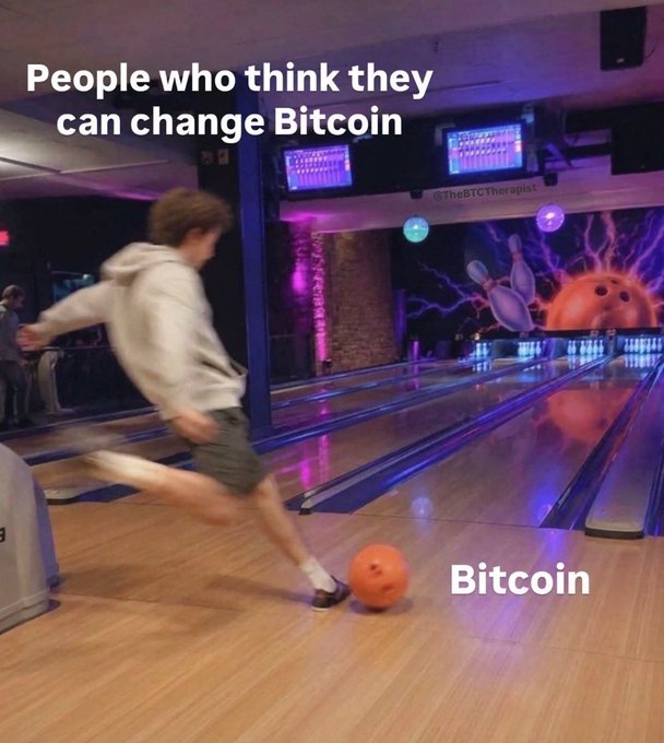 A meme showing a person bowling at a bowling alley with the text 'People who think they can change Bitcoin' above the bowler and 'Bitcoin' labeling the orange bowling ball, with '@TheBTCTherapist' watermark visible.