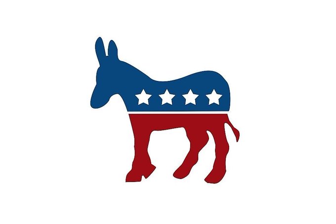 The image is the logo of the Democratic Party, featuring a donkey in blue (top half) and red (bottom half) with four white stars — symbolizing the Senate Democrats mentioned in the article, who are blocking the CLARITY Act.