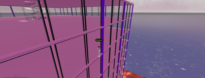A purple-tinted video game scene shows a character scaling the exterior of a tall building next to a body of water.
