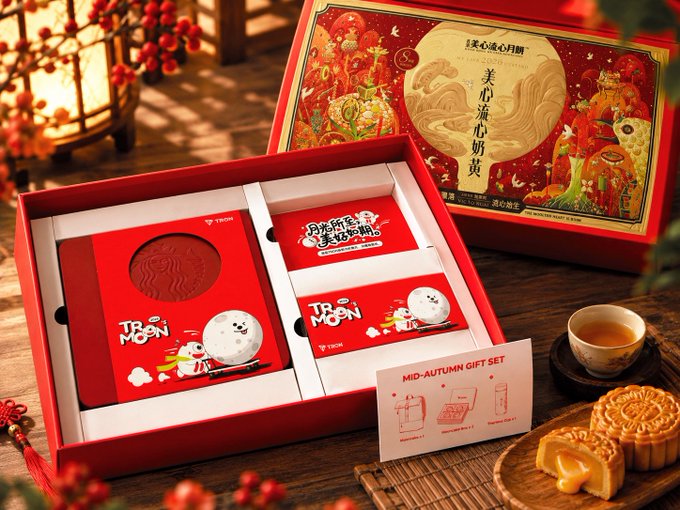 A product display showing a 'TBSN MOON' Mid-Autumn Festival gift set in a red box, featuring mooncakes, a snowman-themed item, and a teacup on a wooden table.