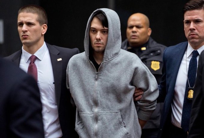 A young man in a gray hoodie is escorted by federal agents and what looks like law enforcement personnel, suggesting his arrest or transport to a court appearance. The image appears unrelated to the post about Pumpfun and the DJT token, likely depicting Martin Shkreli (the only identifiable text is a badge reading "POLICE") during one of his prior legal proceedings rather than any meme coin controversy.
