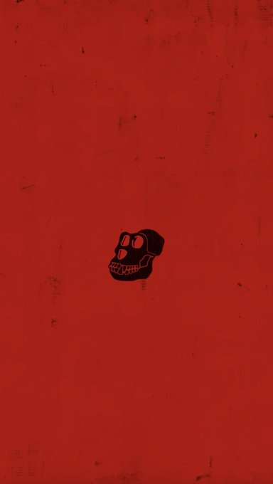 A minimalist red background wallpaper with a small black skull illustration in the center, featuring a distressed/grunge texture.