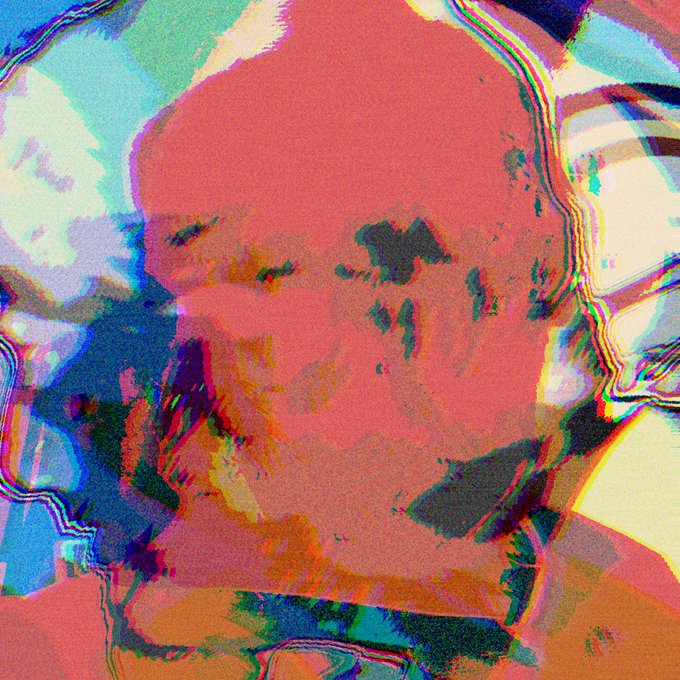 A heavily distorted, glitch-art style image with vibrant pink, red, blue, and green colors, making the subject unrecognizable.