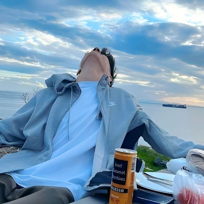 A person leans back relaxed by the ocean with a "Nescafé Original" coffee can nearby, embodying the "lazy" simplicity the post advocates for in DeFi UX—just deposit, use, earn, and move on without the complexity of chains, bridges, or wrapped assets.