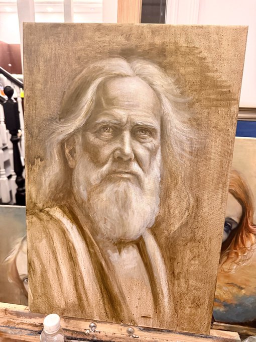 A sepia-toned painted portrait of an elderly man with long, wavy hair and a full beard, displayed on a wooden easel.