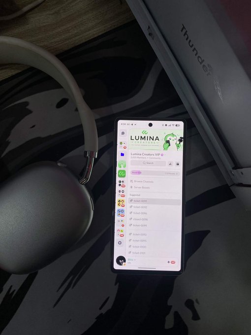 A smartphone displays the Telegram app showing the 'Lumina Creators VIP' channel with 3,039 members, placed next to white headphones on a black and white patterned surface.