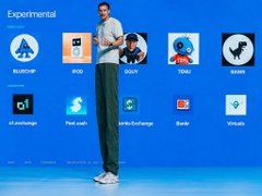 A man standing on a stage during a presentation about experimental AI tools, with icons displayed on a blue screen behind him including BUD-E, IROI, DUIX, TALK2, SIREN, followed by a second row showing chat.d-i.xyz, full-cash, wide-exchange, Gaze, and Whisper.