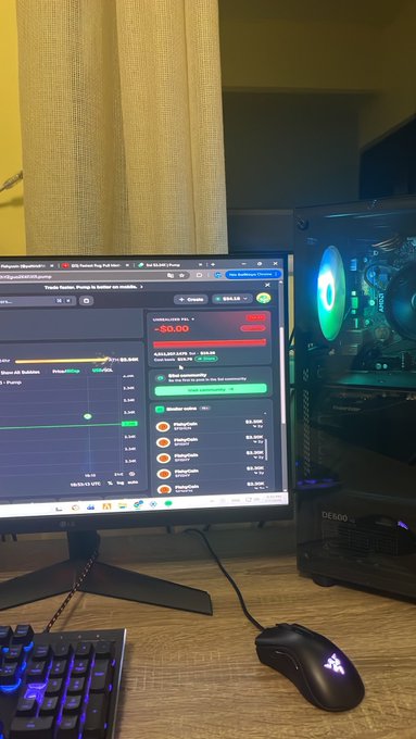 A trading setup featuring an LG monitor displaying a trading chart with a -$5.00 indicator, a gaming PC with RGB lighting, a mechanical keyboard, and a Razer mouse on a wooden desk.