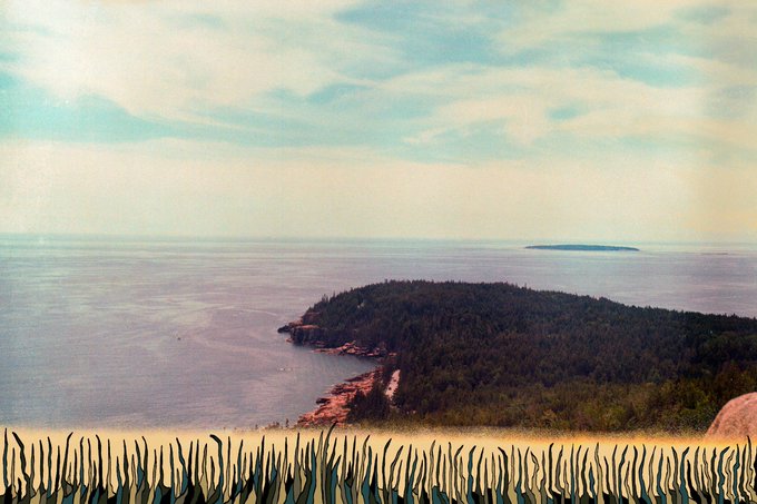 Vintage-style photograph of a forested island or peninsula along a calm coastline with another small island visible in the distance, framed with a painted wavy border at the bottom.
