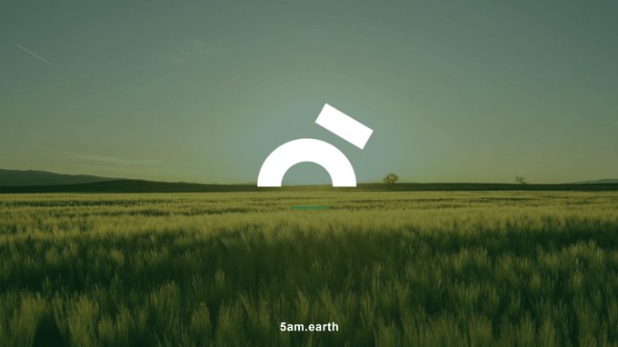 The image shows a large field of tall grass with a white logo that reads "CARDANO" at the center, surrounded by a blue sky. The text above the logo says "It is 5 am somewhere wake up Cardano We hear a lot that CARDANO needs ADOPTION By end of 2027, 5am.earth: 500k farmers ⁠2M transactions $2M in loans ⁠ Partnership".