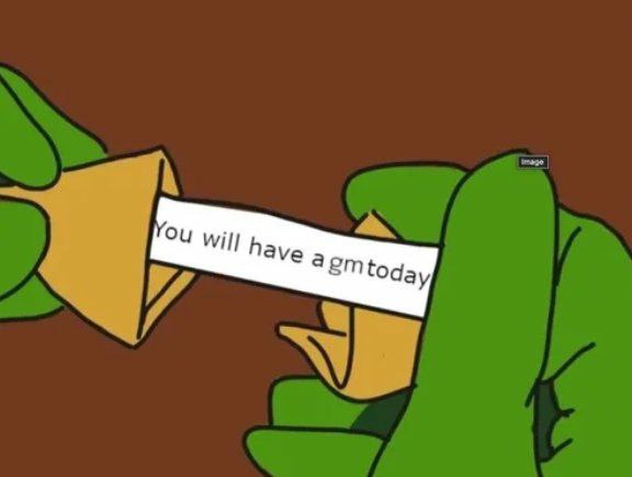 A cartoon illustration shows green-gloved hands pulling a fortune cookie open to reveal a paper slip reading "You will have a gm today," cleverly playing on the "gm" (good morning) internet greeting by framing it as a daily fortune.