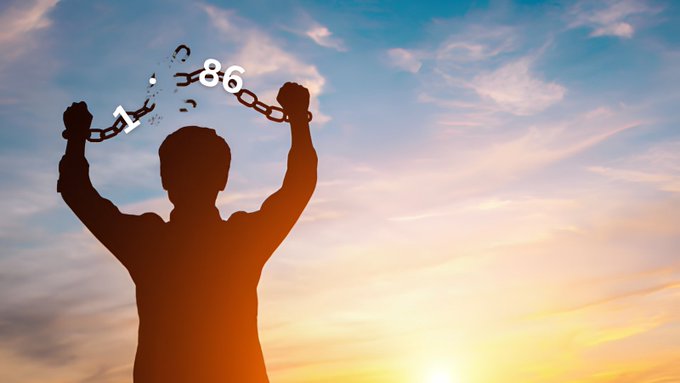 The image features a person holding a chain above their head with both hands, giving the impression that they are trying to break free from something or someone attached to the chain. The backdrop of the image depicts a beautiful sunset sky, adding to the overall visual appeal of the scene.
