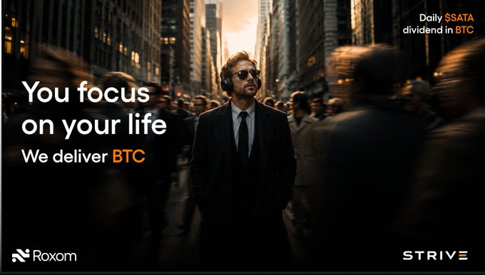 The image features a man wearing sunglasses, standing in front of a cityscape with tall buildings at night. The text on the image reads "You focus on your life We deliver Btc". This suggests that the image might be related to Bitcoin or cryptocurrency, as the man is dressed in a suit and appears to be promoting Bitcoin.