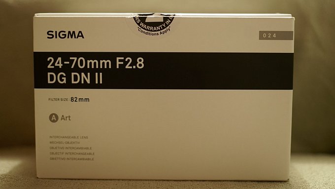 A box for a Sigma 24-70mm F2.8 DG DN II Art interchangeable lens with an 82mm filter size, marked with a '6 Years Warranty' seal.